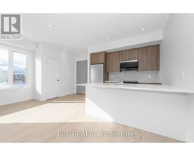 A spacious kitchen with wooden cabinets and a stainless steel refrigerator.