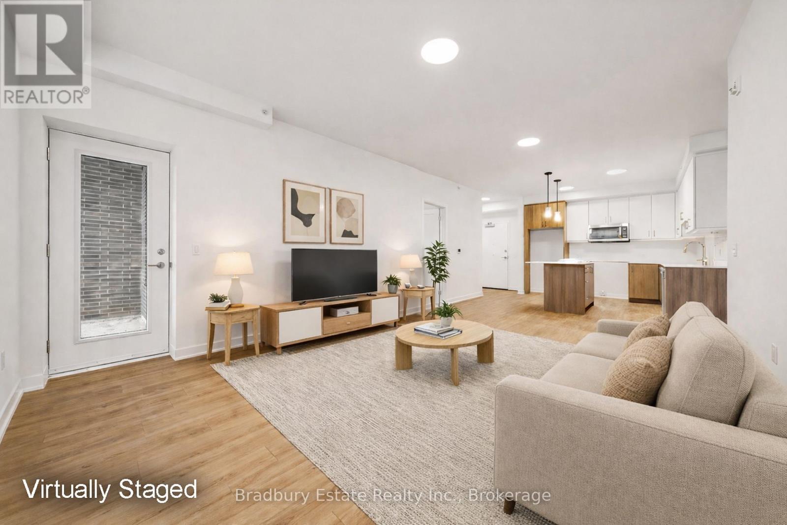 A living room with a couch, a coffee table, and a television.