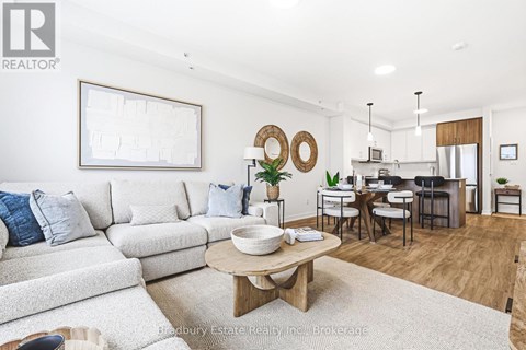 A modern living room with a white couch and a wooden coffee table.
