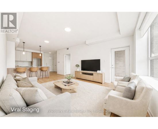 A living room with a large couch and a flat screen TV.