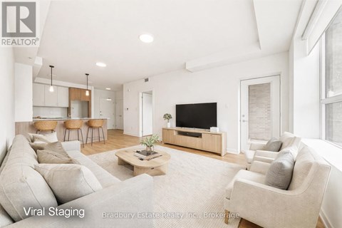 A living room with a large couch and a flat screen TV.