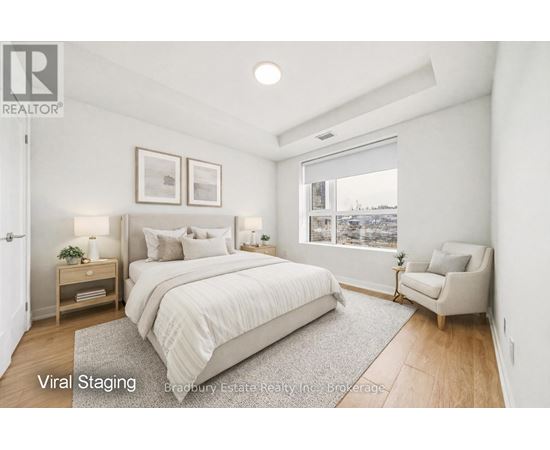 A bedroom with a large bed and a chair.