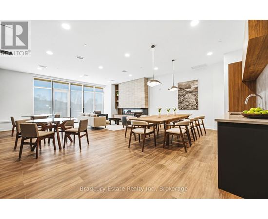 A modern dining room with wooden floors and furniture.