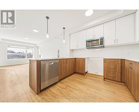 A modern kitchen with wooden cabinets and a stainless steel dishwasher.
