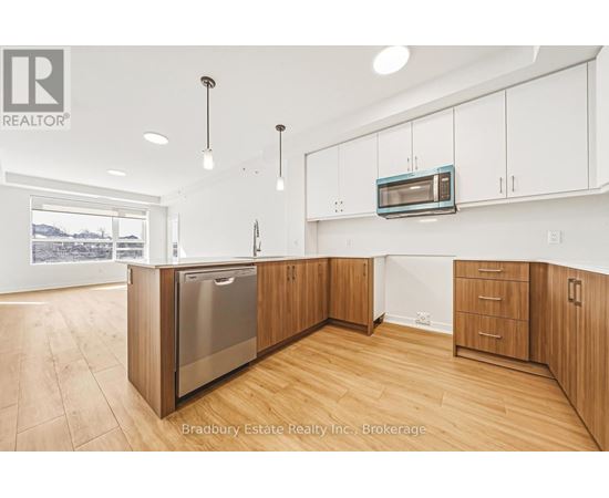 A modern kitchen with wooden cabinets and a stainless steel dishwasher.