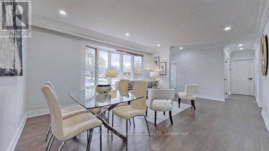 A dining room with a glass table and chairs.