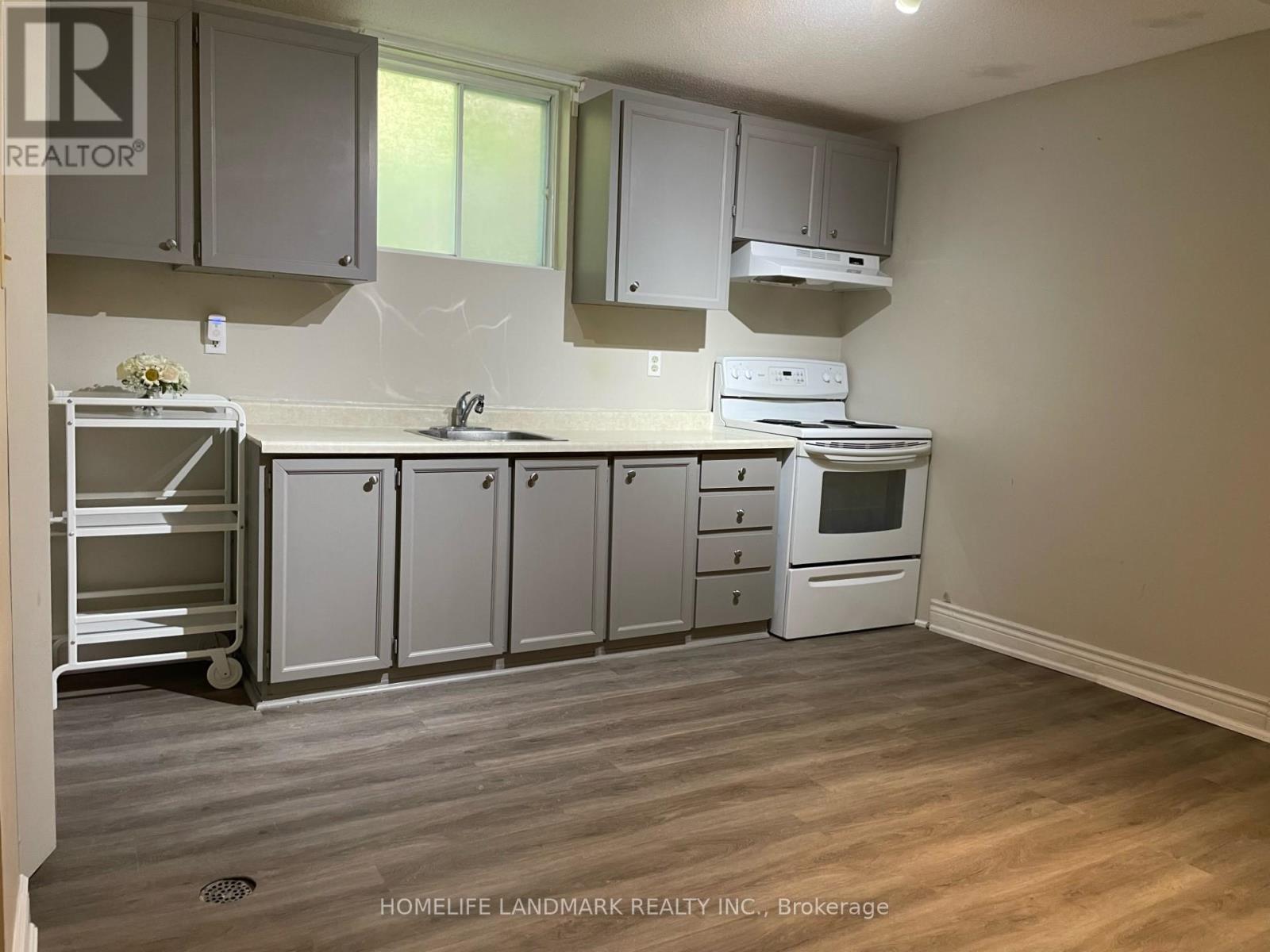 A kitchen with a white fridge, white cabinets, and a white oven.