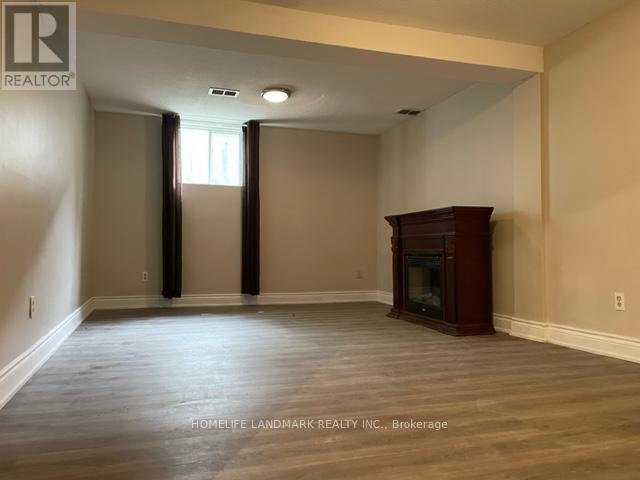 A room with a fireplace and a large window.