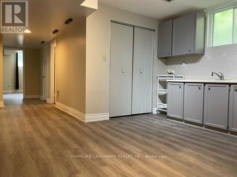 A kitchen area with cabinets and a sink.