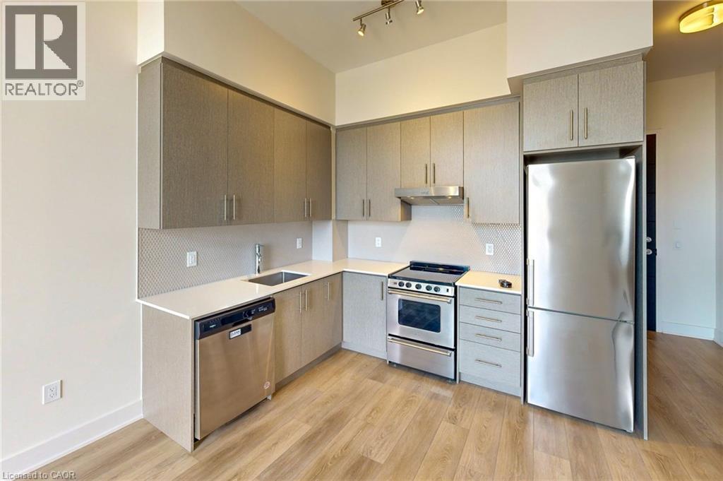 A kitchen with a refrigerator, stove, and oven.
