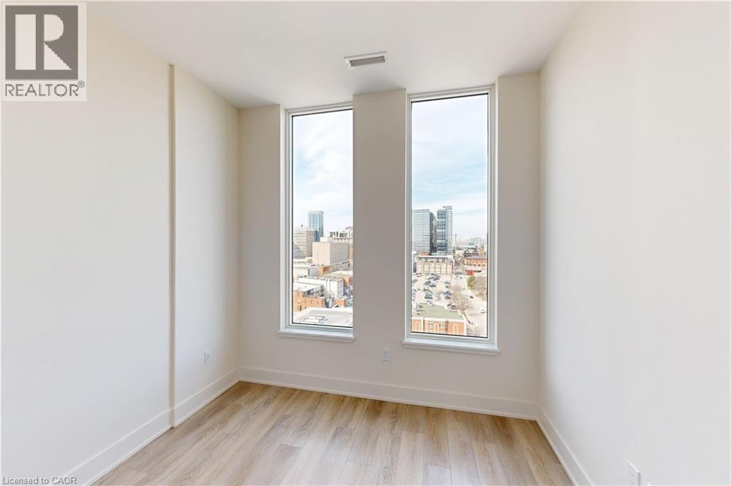 A room with a large window overlooking a cityscape.
