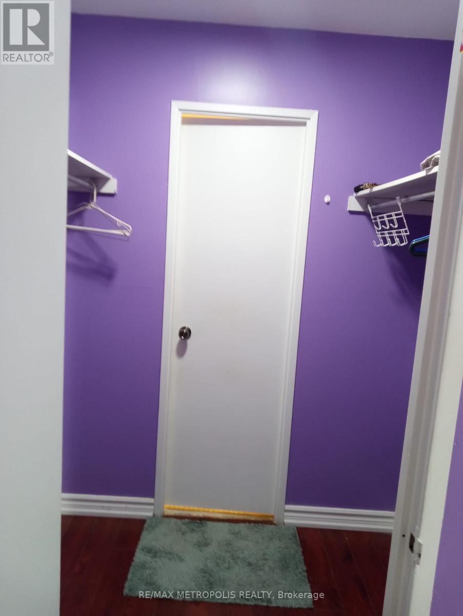 A white door is in a room with purple walls.