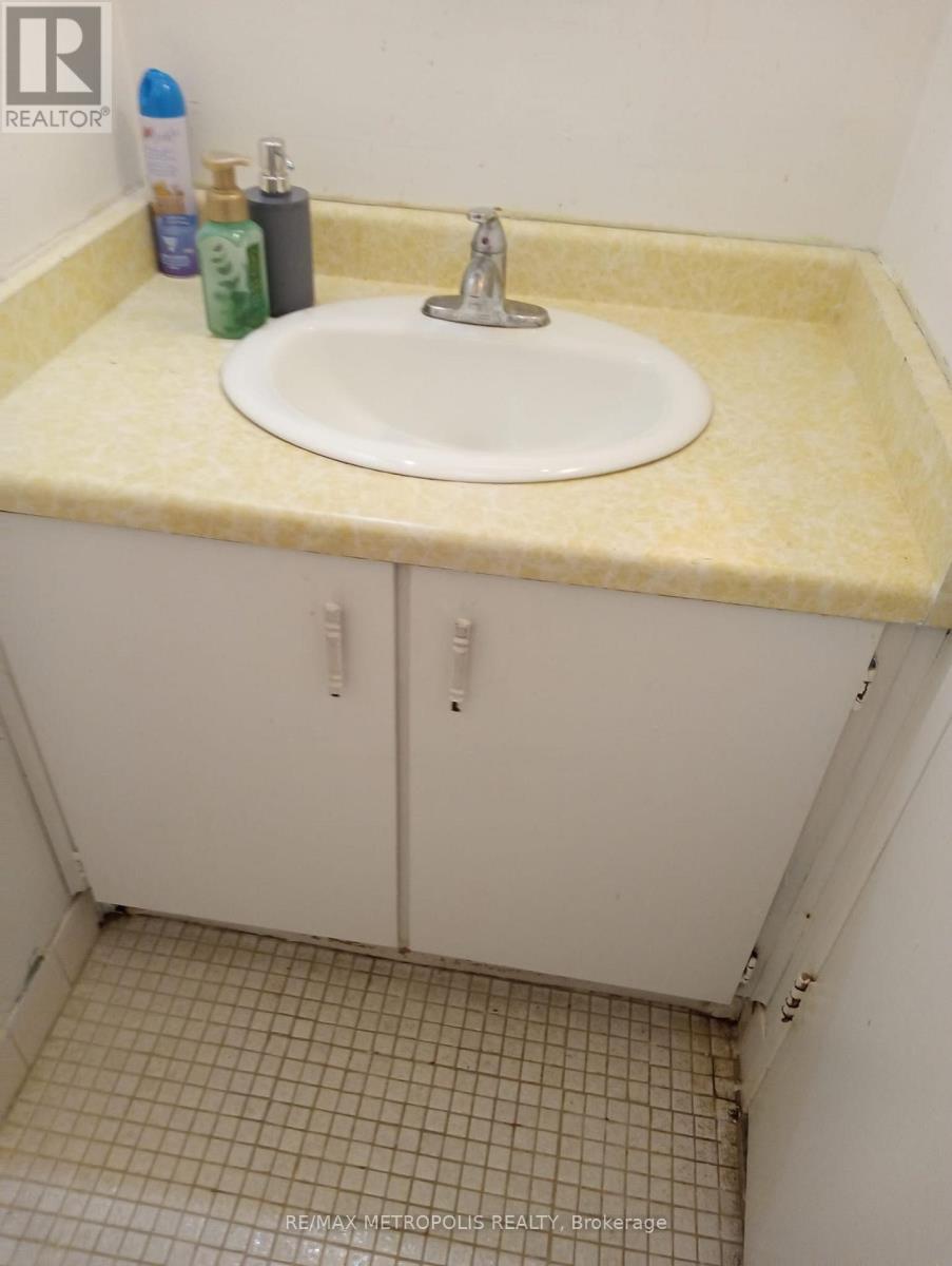 A bathroom with a sink and a cabinet.