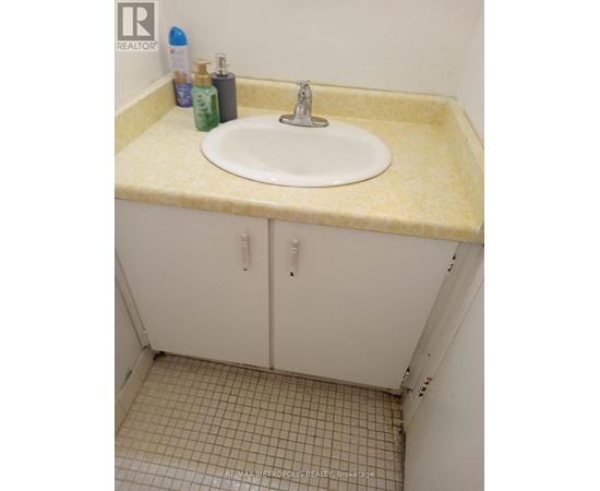 A bathroom with a sink and a cabinet.