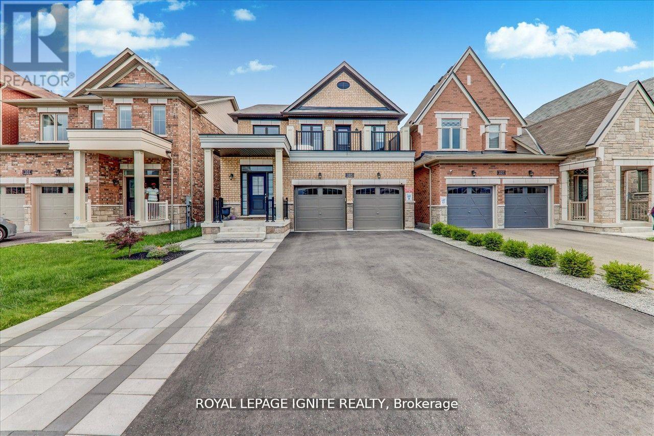 A large, well-maintained house with a driveway in front is for sale.