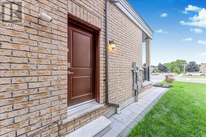 A brick house with a brown door and a small window.