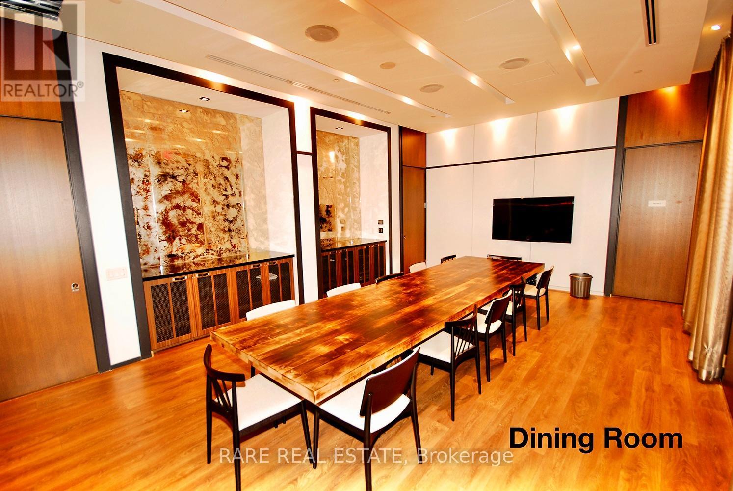 A dining room with a long table and chairs.