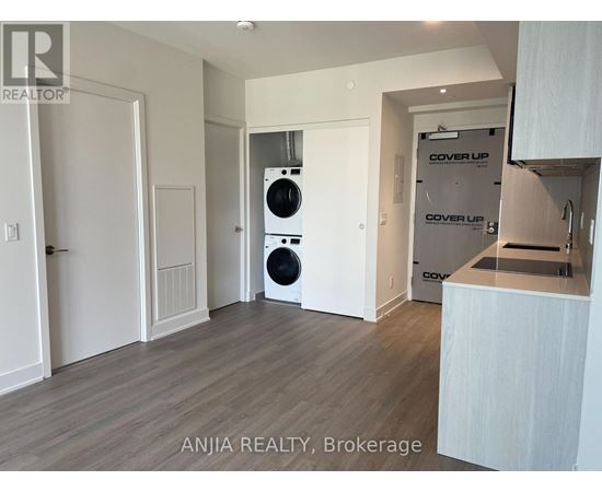 A modern kitchen with a dishwasher and a washing machine.