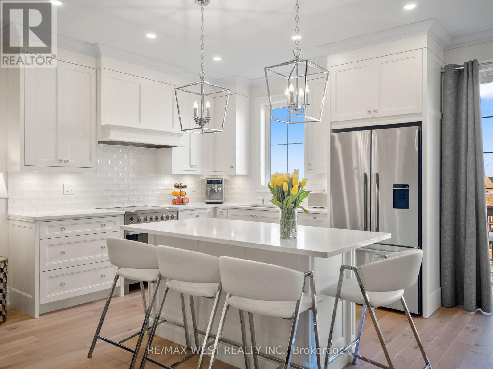 A modern kitchen with a dining table and chairs.