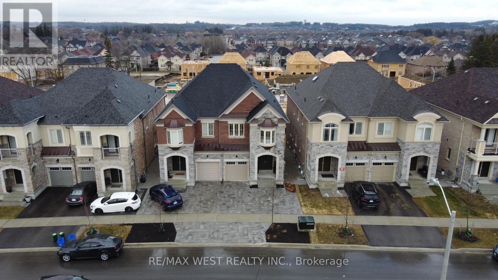 A brokerage sign is displayed on a building in a residential area.