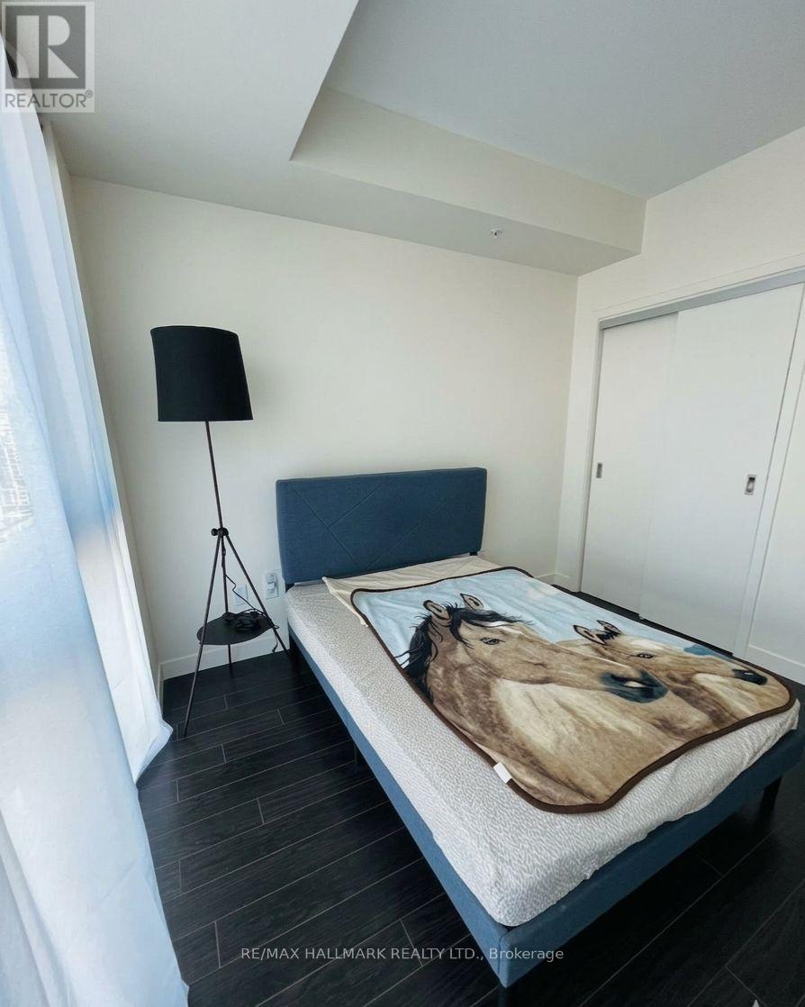 A bedroom with a bed covered in a horse print sheet.