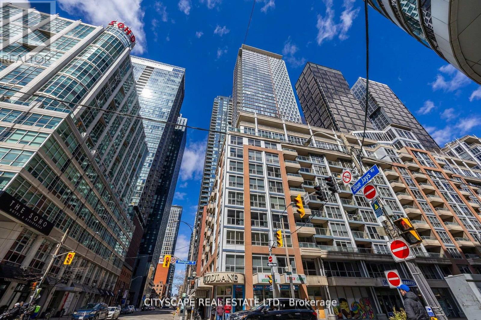 A cityscape with tall buildings and a clear blue sky.