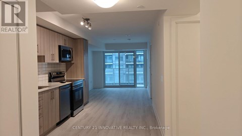 A kitchen with wooden cabinets and black appliances is shown.