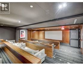 A conference room with a long table and chairs.
