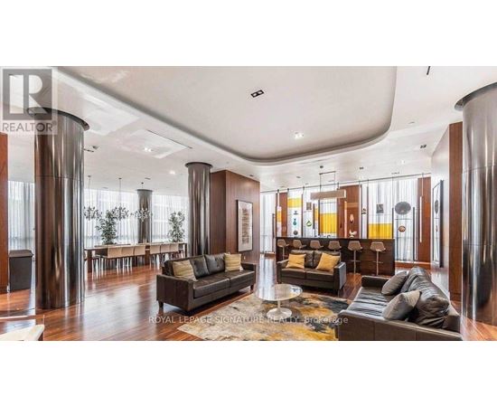 A living room with a black couch and a coffee table.