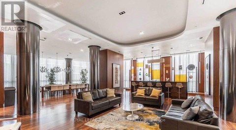 A living room with a black couch and a coffee table.