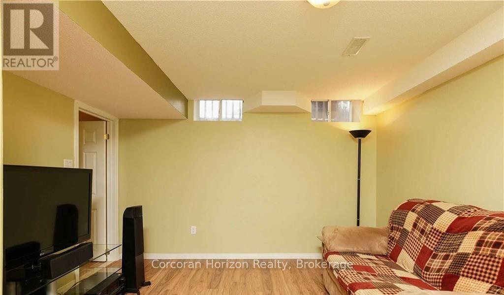 A living room with a flat screen TV and a couch.