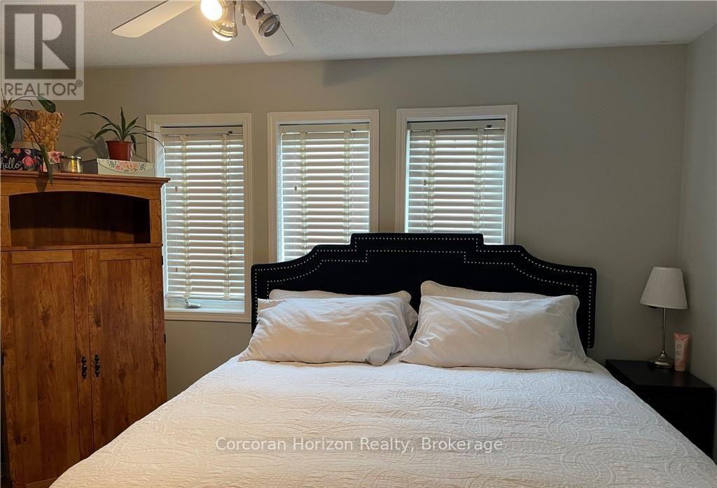 A bedroom with a large bed and a wooden cabinet.