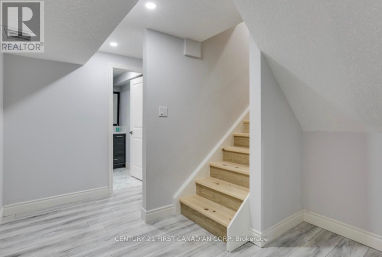 A hallway with a staircase leading to the second floor.