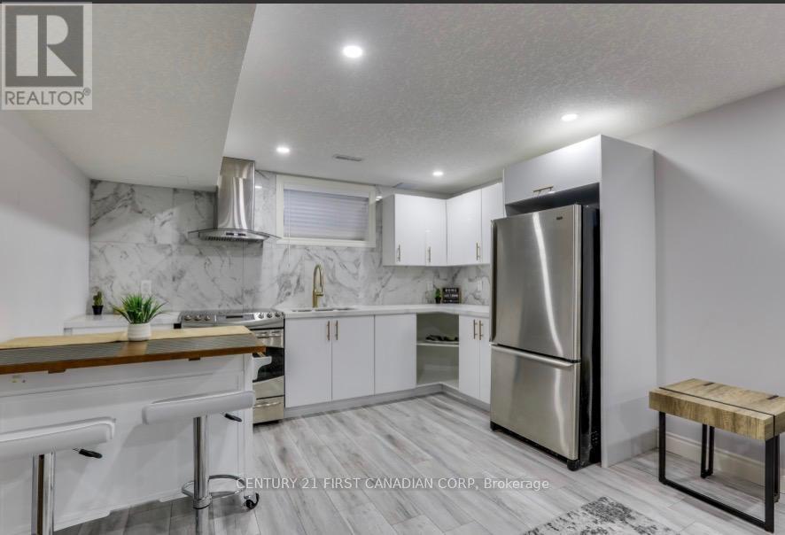 A modern kitchen with stainless steel appliances and white cabinets.