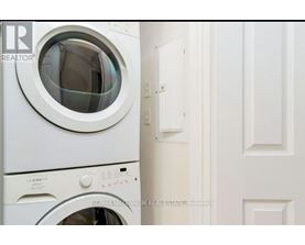 A white washing machine with the door open.