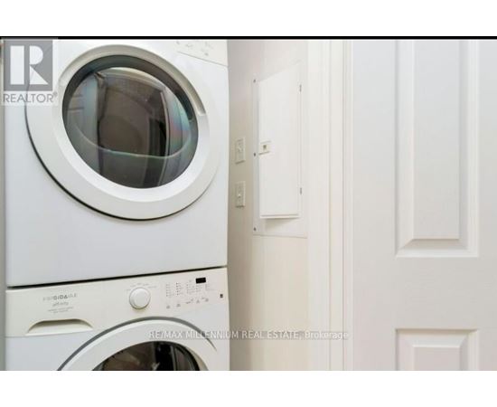 A white washing machine with the door open.