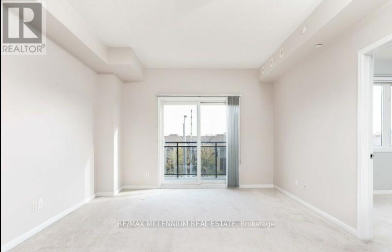 A spacious room with a view of a balcony through a glass door.
