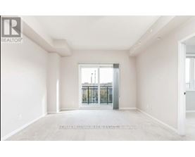 A spacious room with a view of a balcony through a glass door.