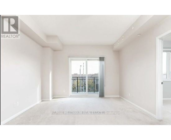 A spacious room with a view of a balcony through a glass door.