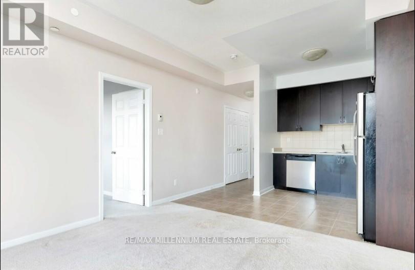 A real estate listing photo of a kitchen and living room.