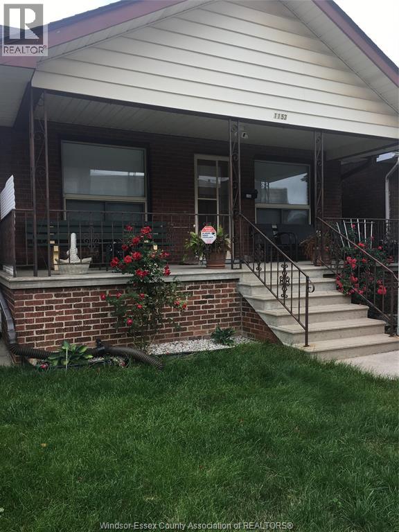 A house with a red and white sign on the front door.