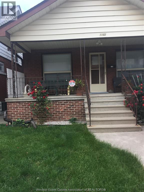 A house with a white door and a brick wall.