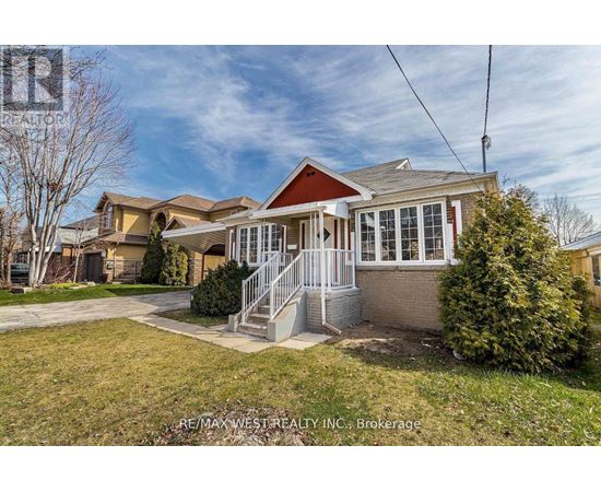 A house with a red roof and a white fence is for sale.