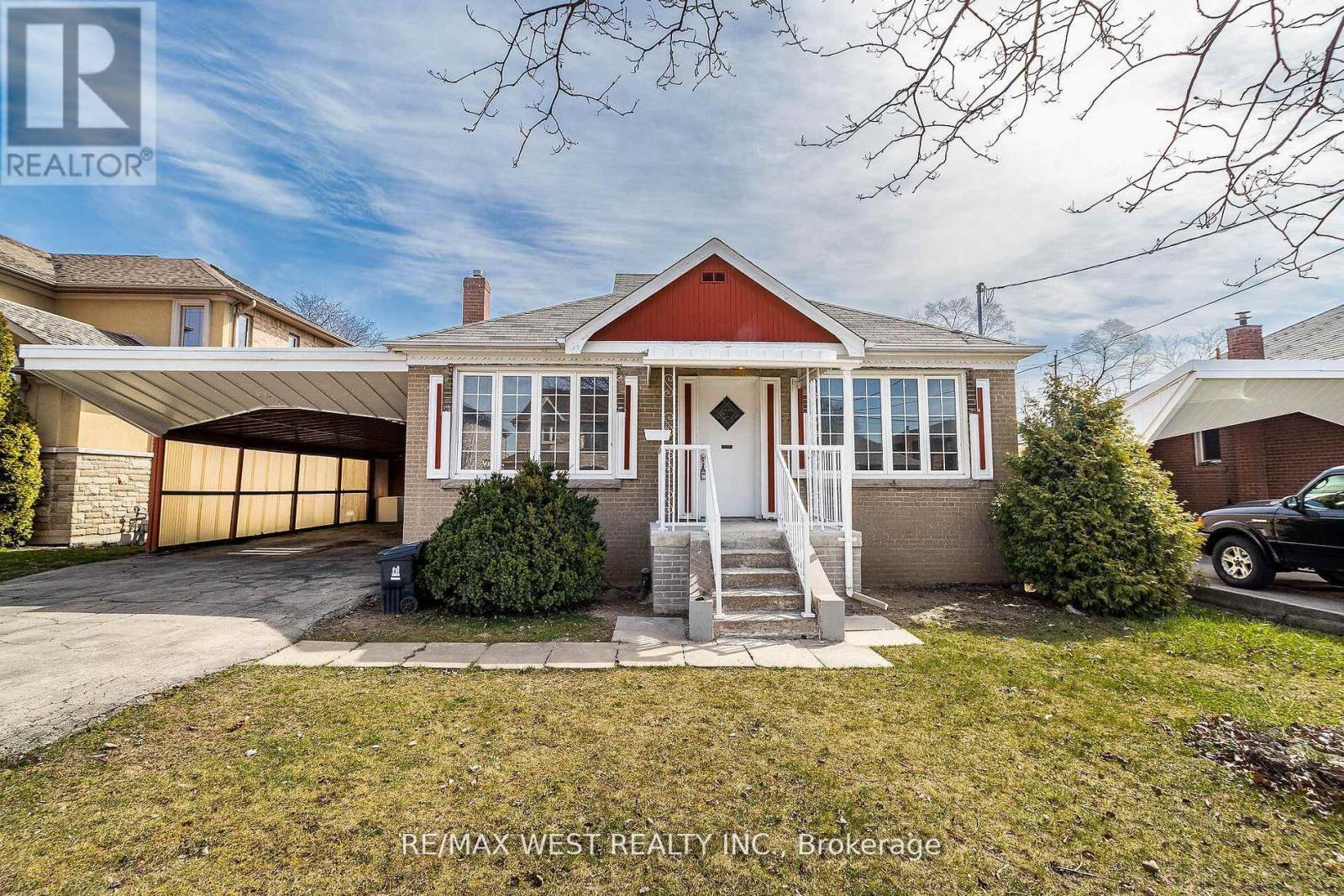 A house with a red roof and a garage door is for sale.