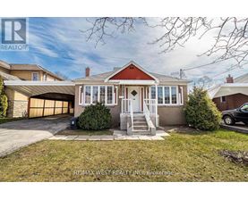 A house with a red roof and a garage door is for sale.