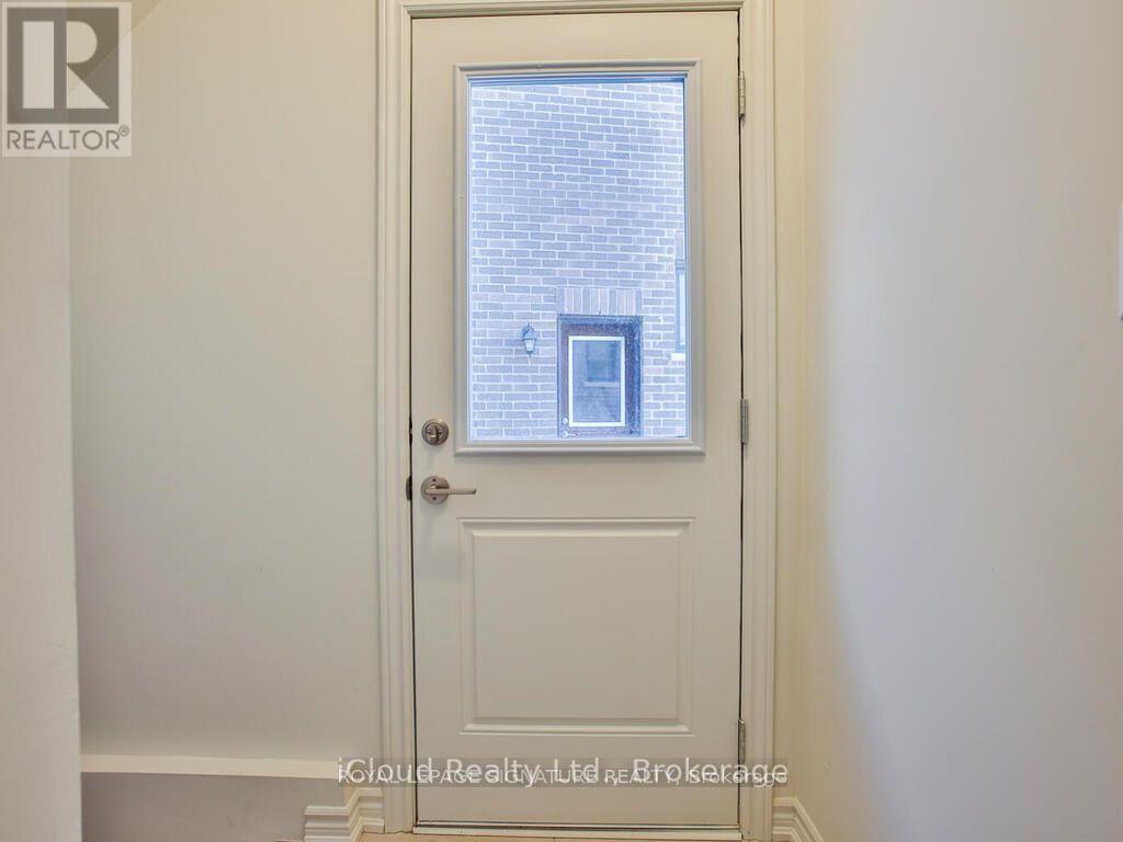 A white door with a glass window in the middle.