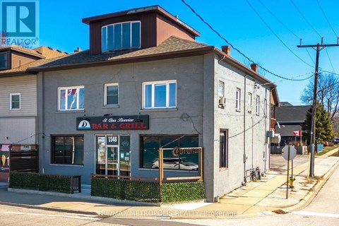 A building with a bar and grill sign on the front.