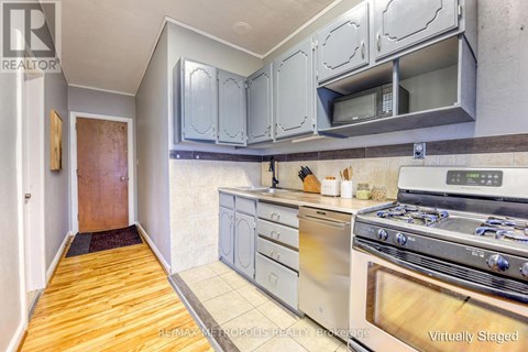 A kitchen with a stove top oven and cabinets above it.