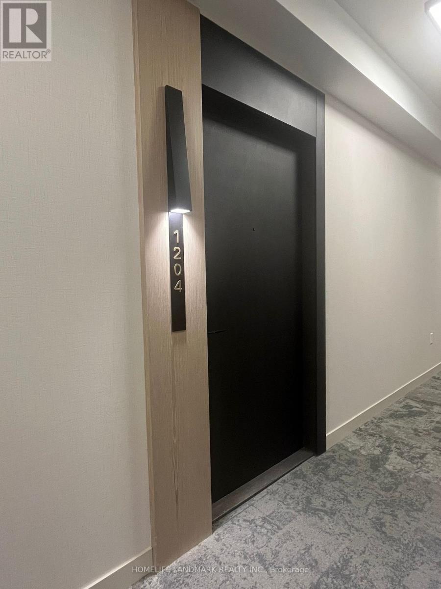 A black door with a wooden frame and a number 1204 on it.