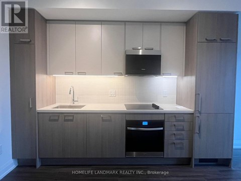 A modern kitchen with wooden cabinets and a stainless steel oven.